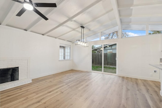 unfurnished living room featuring lofted ceiling with beams, ceiling fan, a fireplace, and light hardwood / wood-style floors