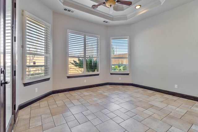 spare room with a raised ceiling, ceiling fan, and crown molding