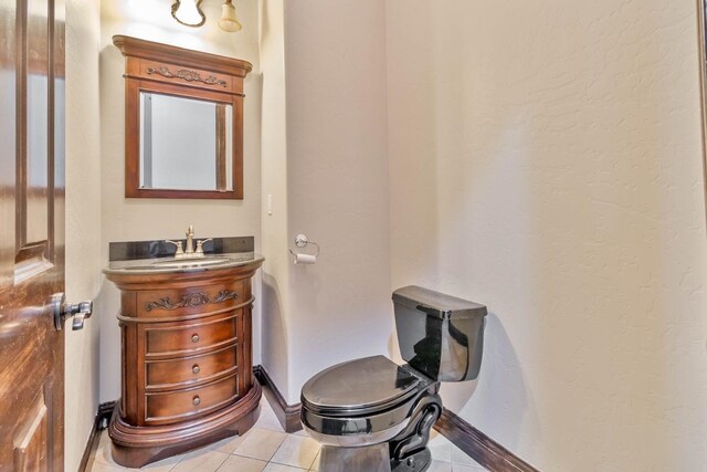 bathroom featuring tile patterned floors, vanity, and toilet