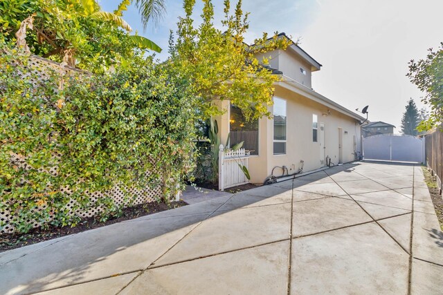 view of side of home with a patio