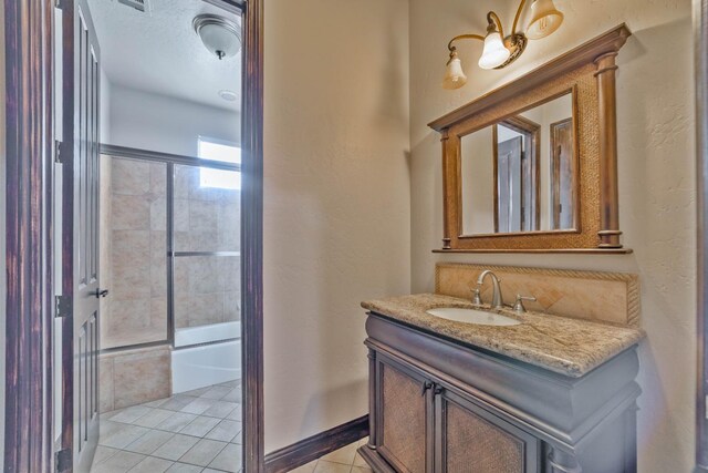 bathroom featuring tile patterned floors, vanity, and shower / bath combination with glass door