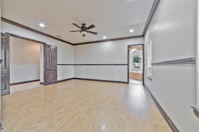 unfurnished room with ceiling fan, crown molding, and light wood-type flooring