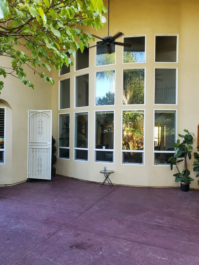 view of exterior entry with ceiling fan