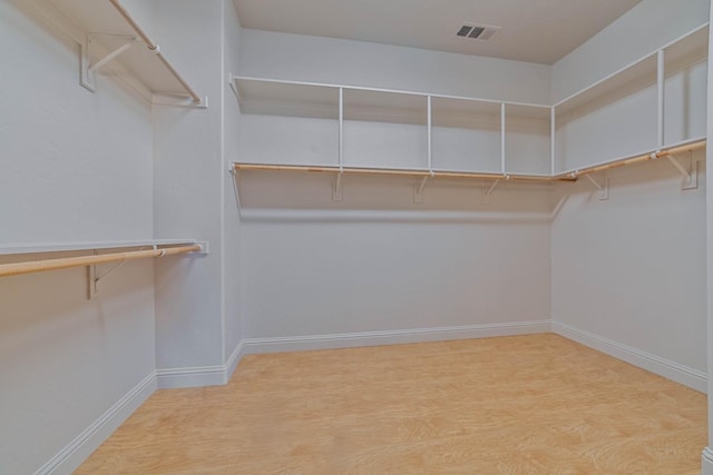 spacious closet featuring hardwood / wood-style floors