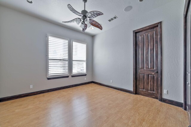 unfurnished room with ceiling fan and light wood-type flooring