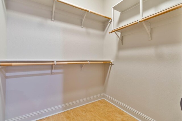 walk in closet featuring hardwood / wood-style floors