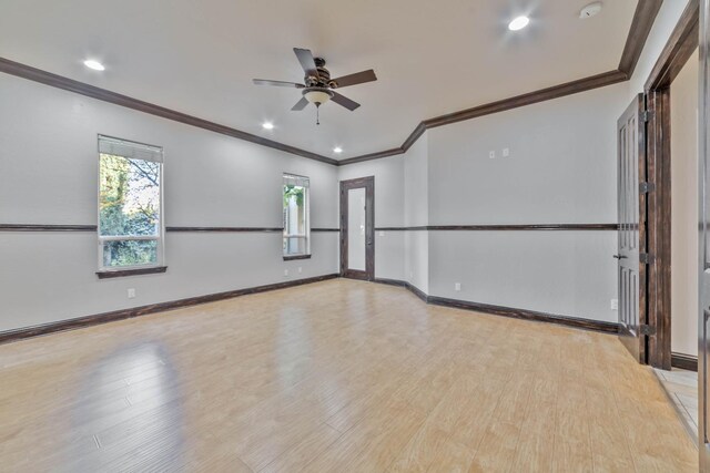 empty room featuring ceiling fan, light wood-type flooring, and ornamental molding