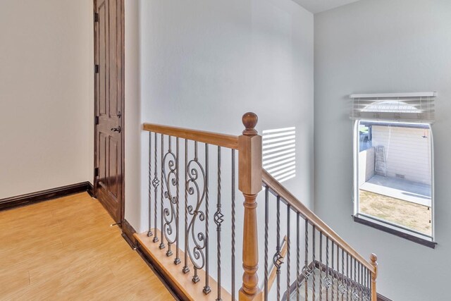 stairs featuring hardwood / wood-style flooring