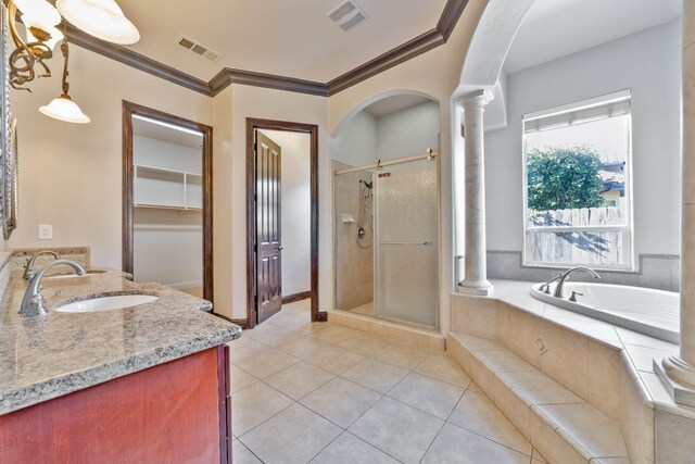 bathroom featuring vanity, tile patterned floors, crown molding, independent shower and bath, and decorative columns