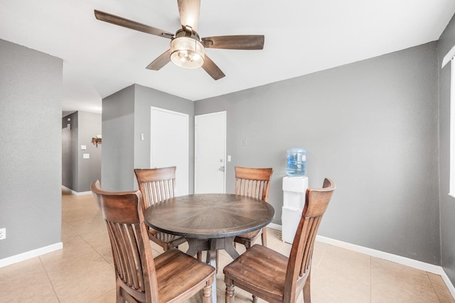 dining area with light tile patterned floors and ceiling fan