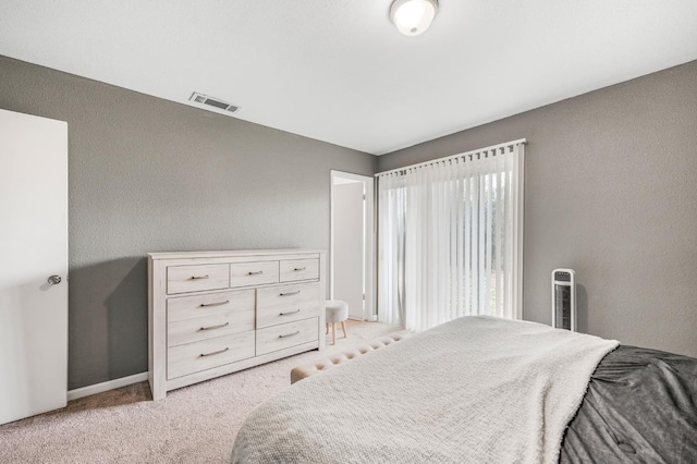 bedroom featuring light carpet