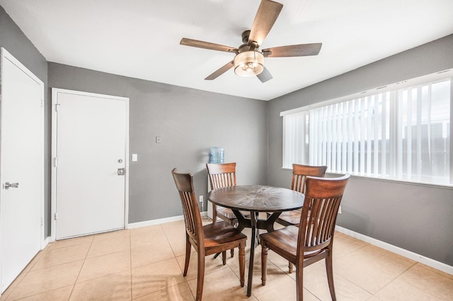 dining area with ceiling fan and light tile patterned flooring