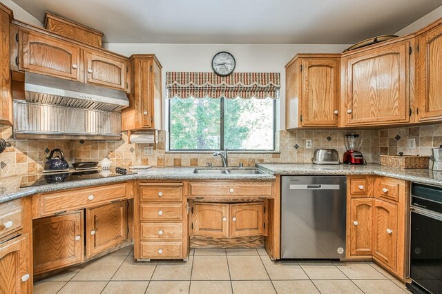 kitchen with black appliances, sink, decorative backsplash, light tile patterned floors, and range hood