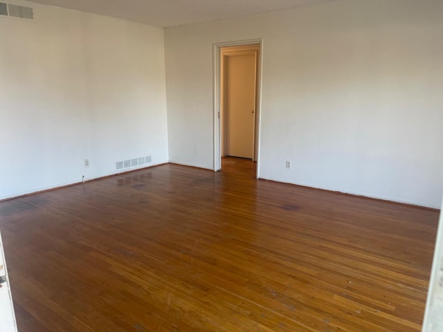 empty room featuring dark wood-type flooring