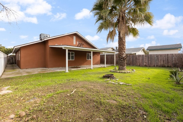 view of yard with central AC and a patio