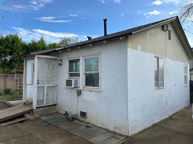 view of side of property with cooling unit