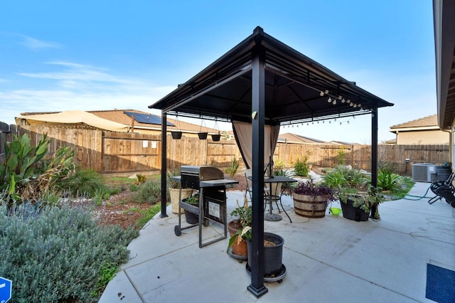 view of patio / terrace featuring a gazebo, cooling unit, and grilling area