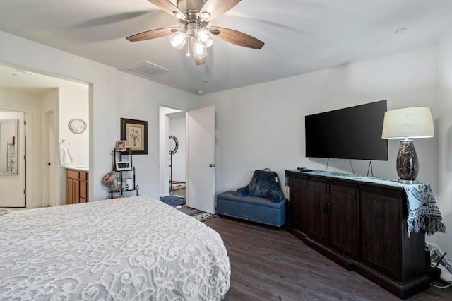 bedroom featuring ceiling fan, dark hardwood / wood-style floors, and ensuite bathroom