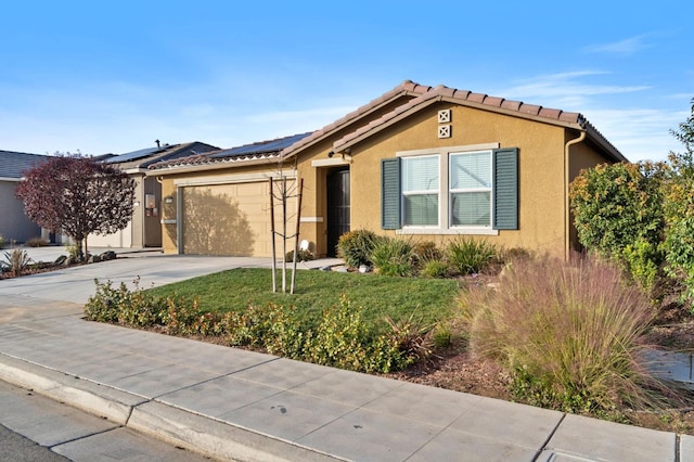 ranch-style home with solar panels and a garage