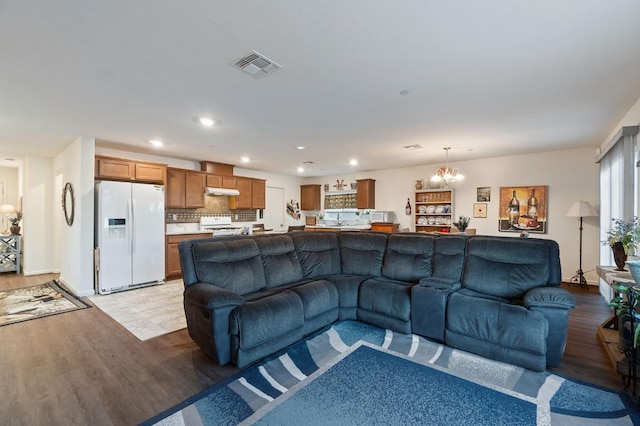 living room featuring a chandelier and light hardwood / wood-style flooring