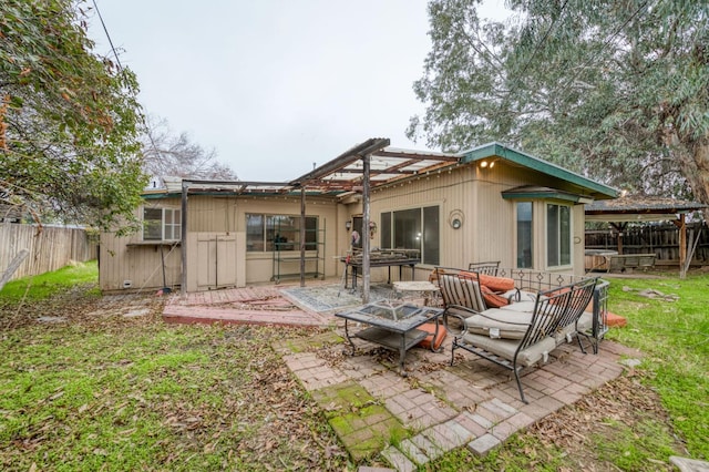 back of house featuring a pergola, a fire pit, and a patio area