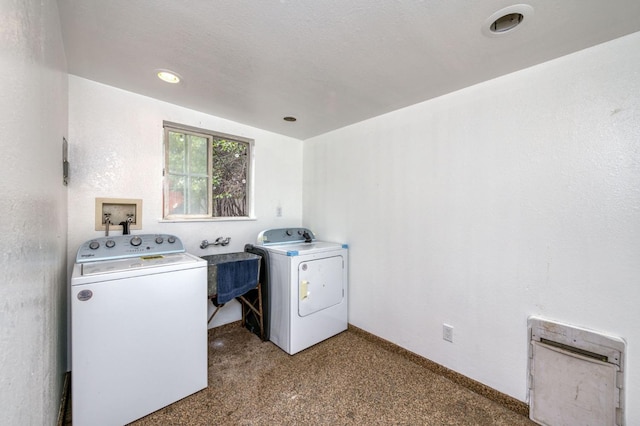 clothes washing area featuring carpet, washer and clothes dryer, and sink