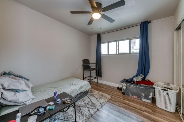 bedroom featuring hardwood / wood-style floors and ceiling fan