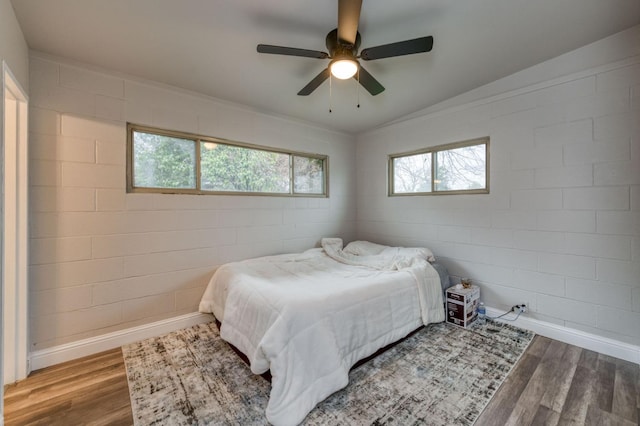 bedroom featuring hardwood / wood-style floors, ceiling fan, and lofted ceiling