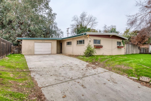 ranch-style house with a garage and a front yard