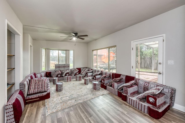 living room with wood-type flooring and ceiling fan