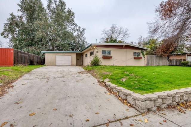 single story home with a garage and a front lawn