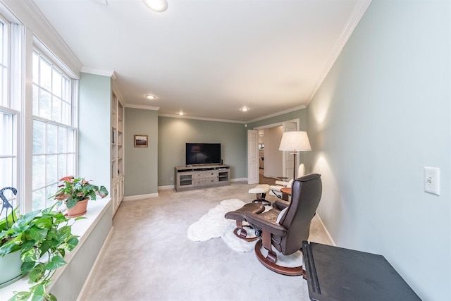 carpeted living room featuring a wealth of natural light and ornamental molding