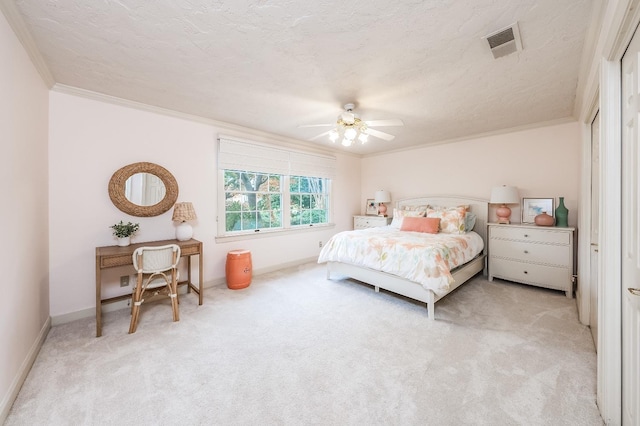 carpeted bedroom featuring a textured ceiling, ceiling fan, and ornamental molding