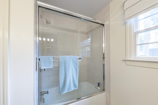 bathroom with shower / bath combination with glass door