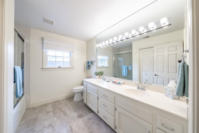 full bathroom with shower / bath combination with glass door, vanity, toilet, and a healthy amount of sunlight