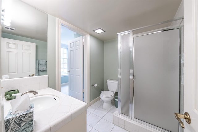 bathroom featuring tile patterned floors, vanity, toilet, and a shower with shower door