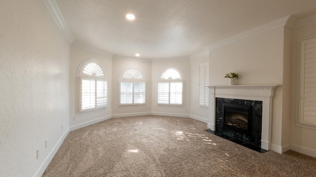 unfurnished living room with crown molding, carpet flooring, and a fireplace