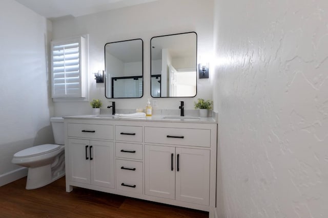 bathroom featuring hardwood / wood-style floors, vanity, and toilet