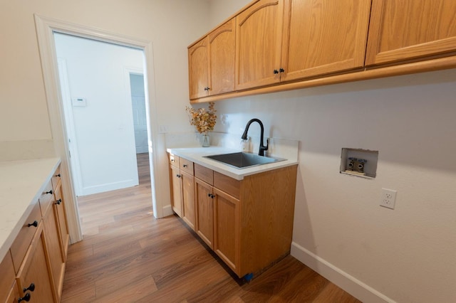 kitchen featuring sink, light brown cabinets, and light hardwood / wood-style flooring