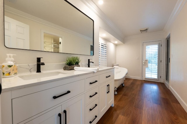 bathroom featuring ornamental molding, vanity, and hardwood / wood-style floors