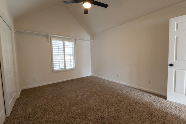 interior space with dark carpet, ceiling fan, and high vaulted ceiling