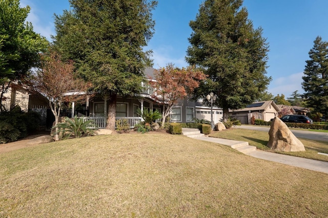 view of front of property with covered porch and a front lawn