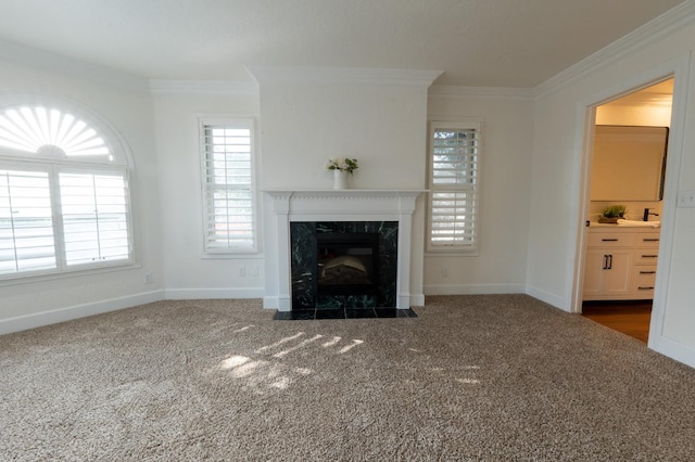 unfurnished living room featuring ornamental molding, dark carpet, and plenty of natural light