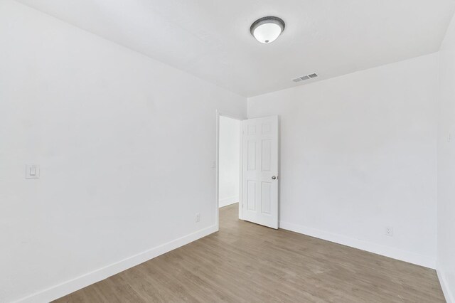 unfurnished room with hardwood / wood-style floors