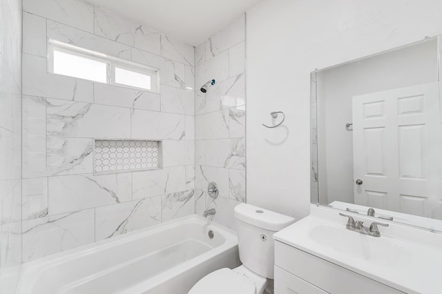 full bathroom with vanity, toilet, and tiled shower / bath