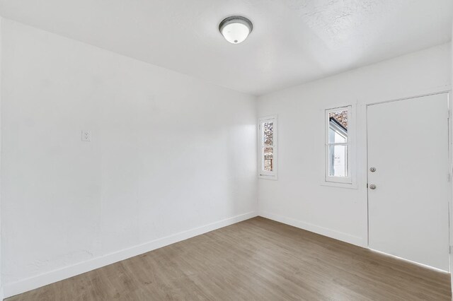 spare room with hardwood / wood-style floors