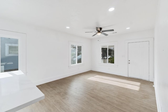 spare room with ceiling fan and light hardwood / wood-style flooring