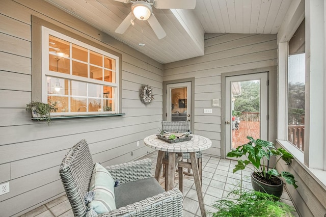 sunroom featuring ceiling fan, lofted ceiling, and wooden ceiling