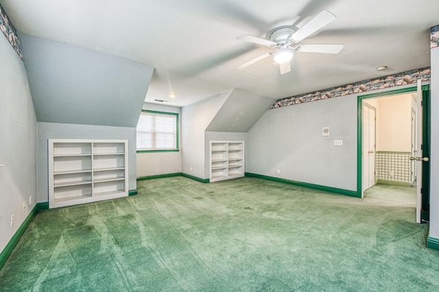 bonus room with ceiling fan, built in features, carpet floors, and vaulted ceiling