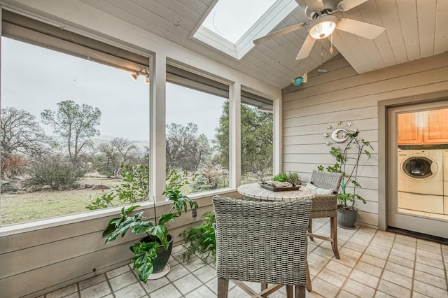 sunroom with washing machine and dryer, lofted ceiling with skylight, ceiling fan, and wooden ceiling